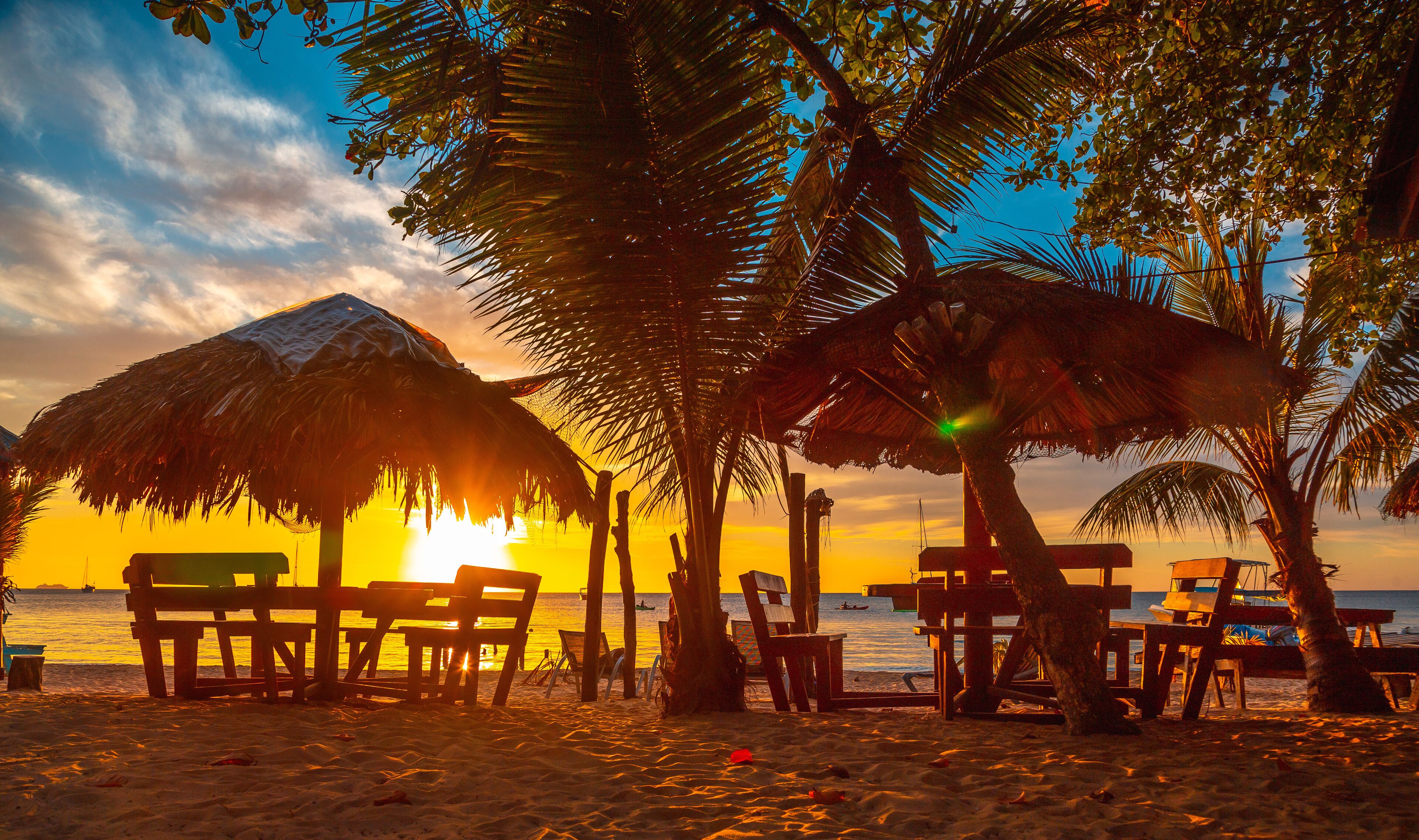 A terrace on the beach at Sunset from West End Beach, Roatan Island. Honduras