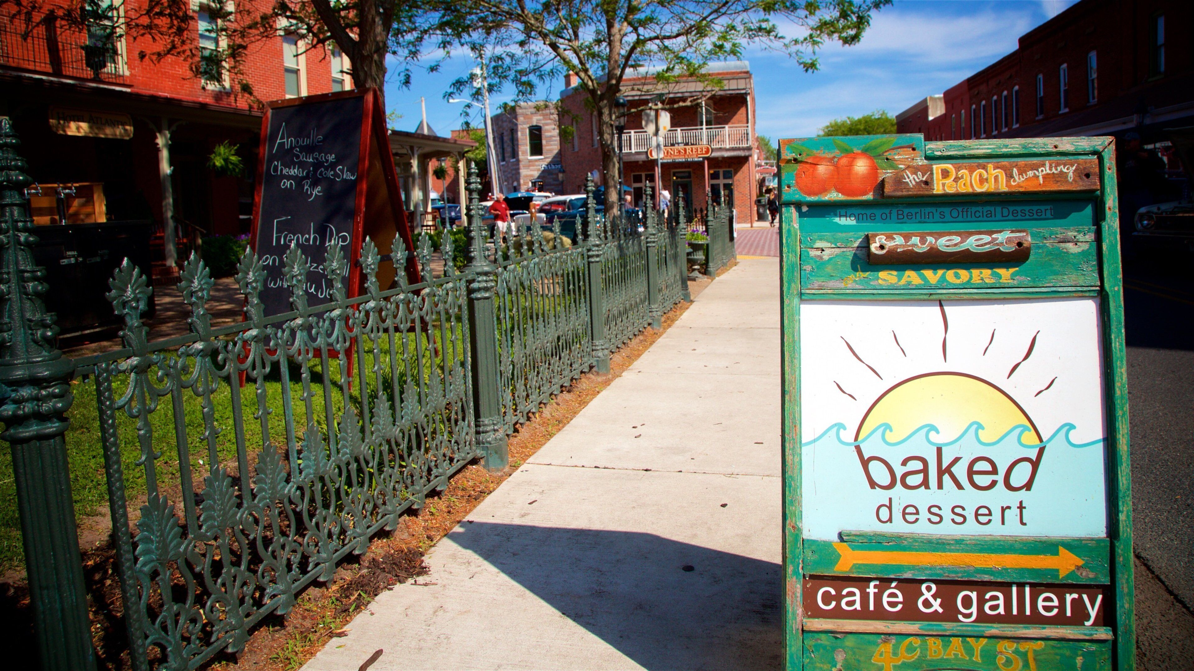 A sidewalk with a sign for 'baked dessert cafe & gallery' and a sign for 'The Patch' restaurant.