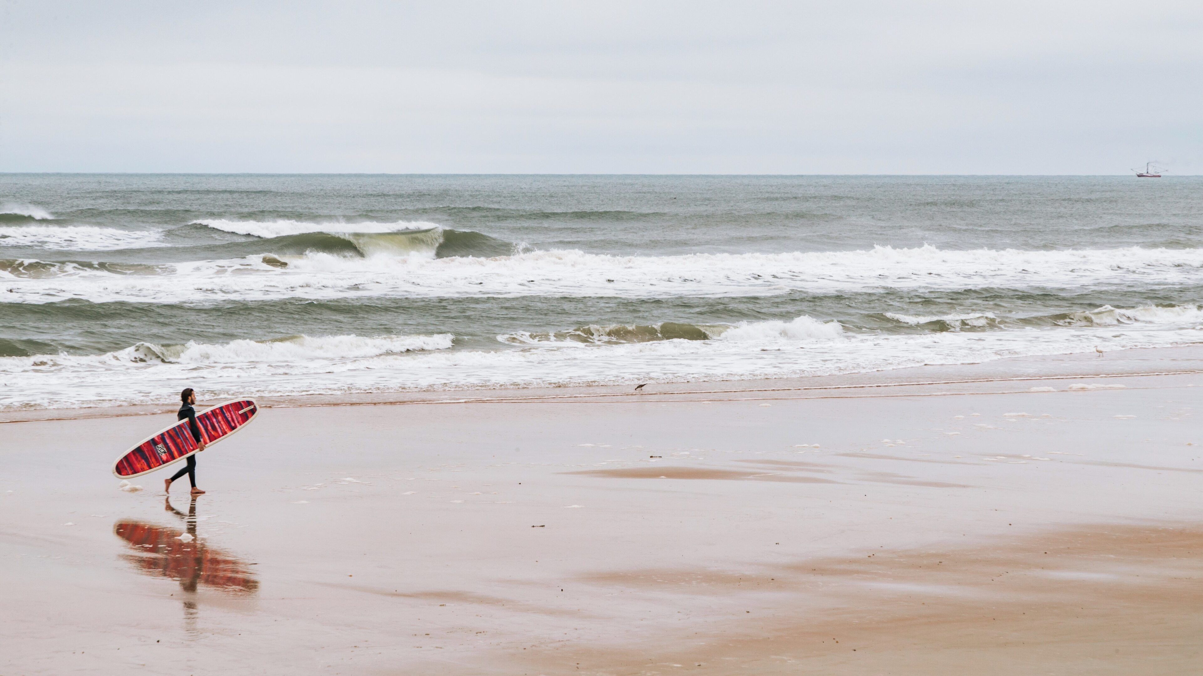 Surfing adventure at Andy Romano Beachfront Park in Ormond Beach, Florida showcases beach activities and ocean waves on a cloudy day