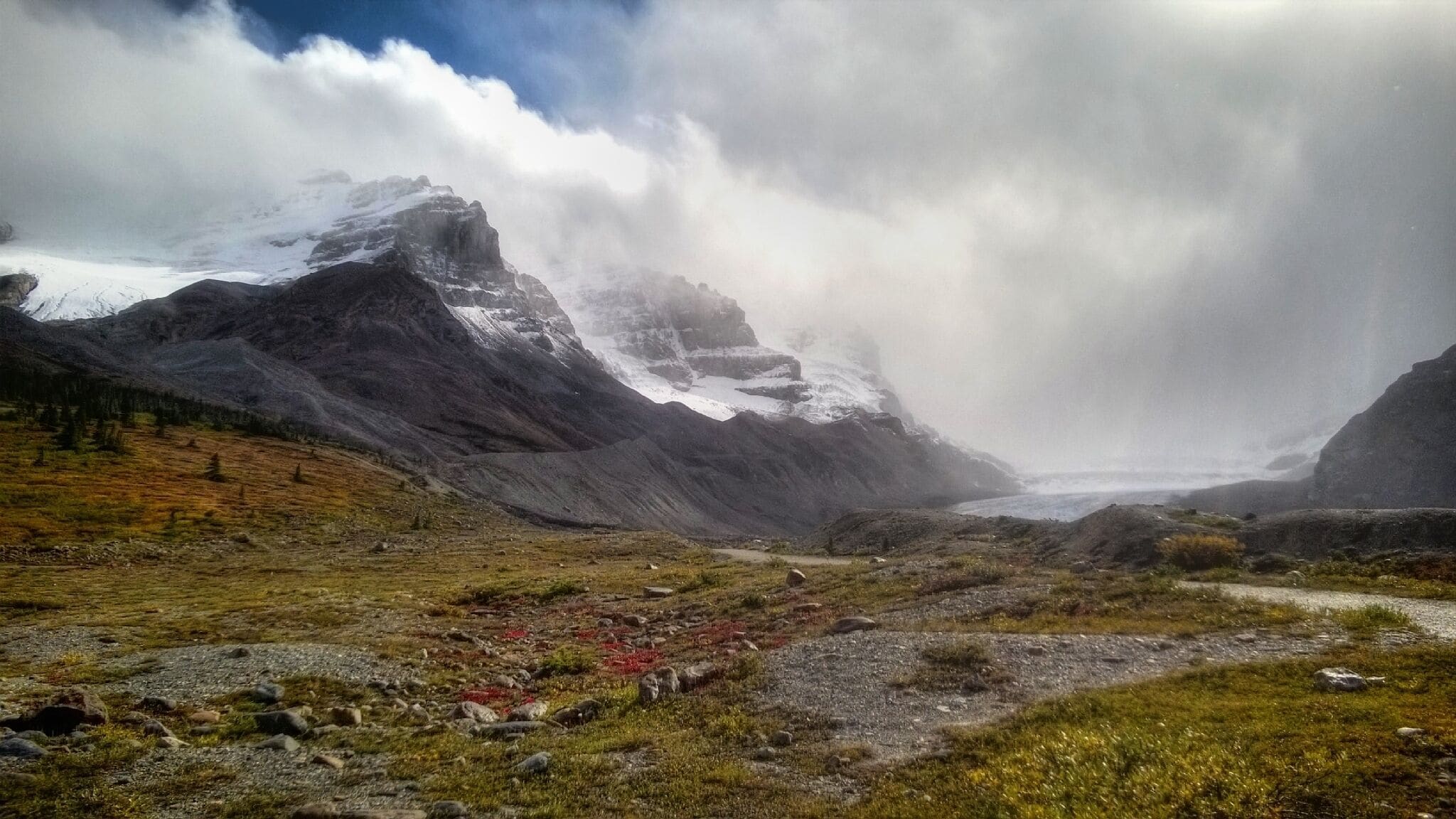 It had been pouring rain so we waited out the weather hoping it would clear up enough to see the mighty Athabasca Glacier and mountain, located along the Icefields Parkway in Jasper National Park. Just as we were running out of time, the clouds cleared and for a brief few moments, the sun came out just long enough to snap this picture. 