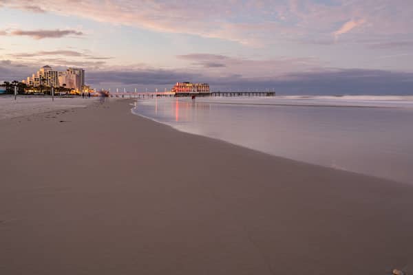 Beach at Daytona Beach which includes a beach, a sunset and general coastal views