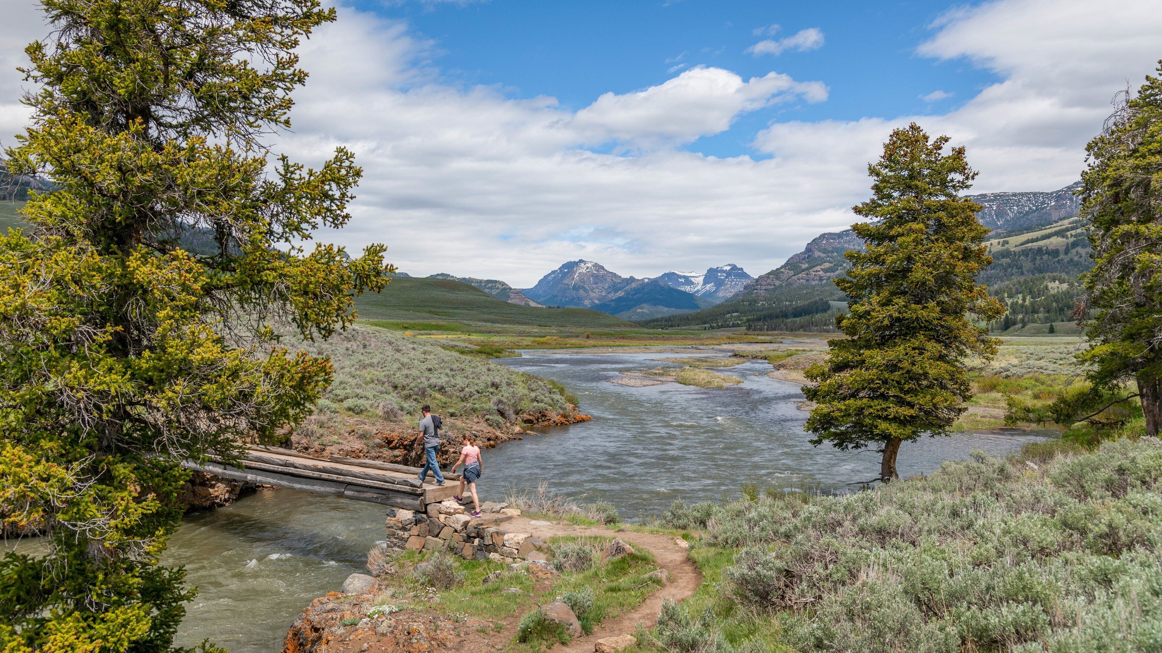 Lamar Valley featuring a river or creek and hiking or walking as well as a couple