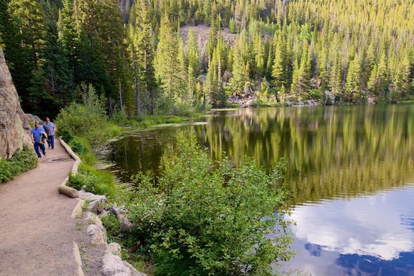 Bear Lake Trailhead showing a lake or waterhole as well as a small group of people