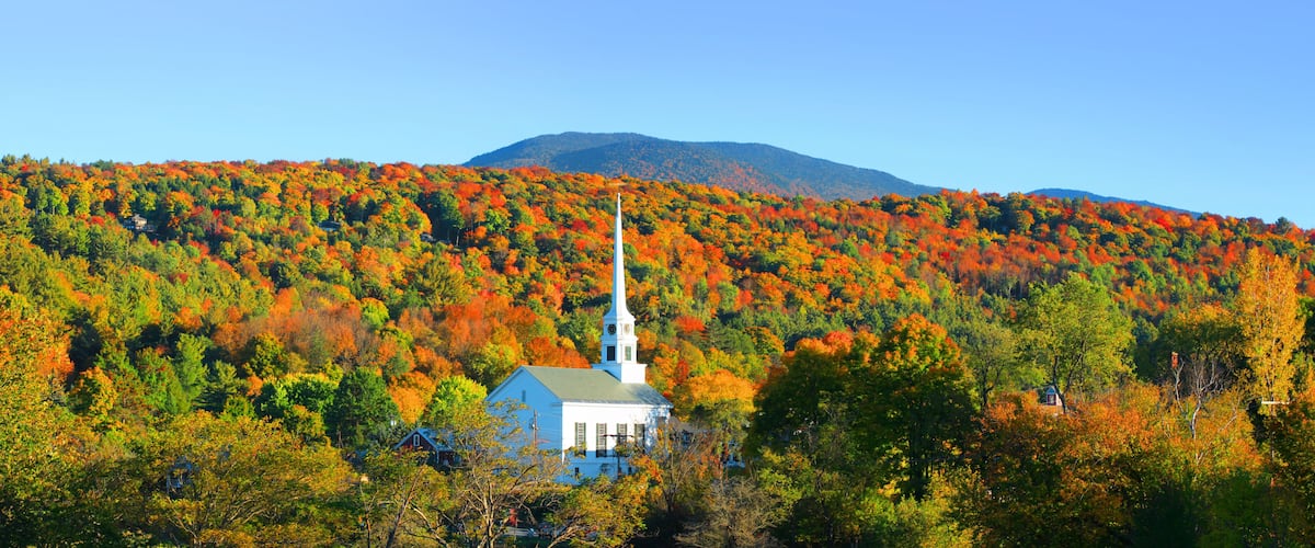 Iconic church in Stowe Vermont middle of fall foliage
