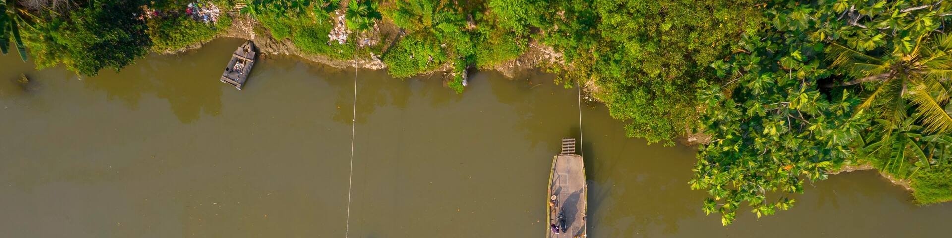 Aerial view of Boat sledding to cross the river. Bekasi, Indonesia, July 9, 2021