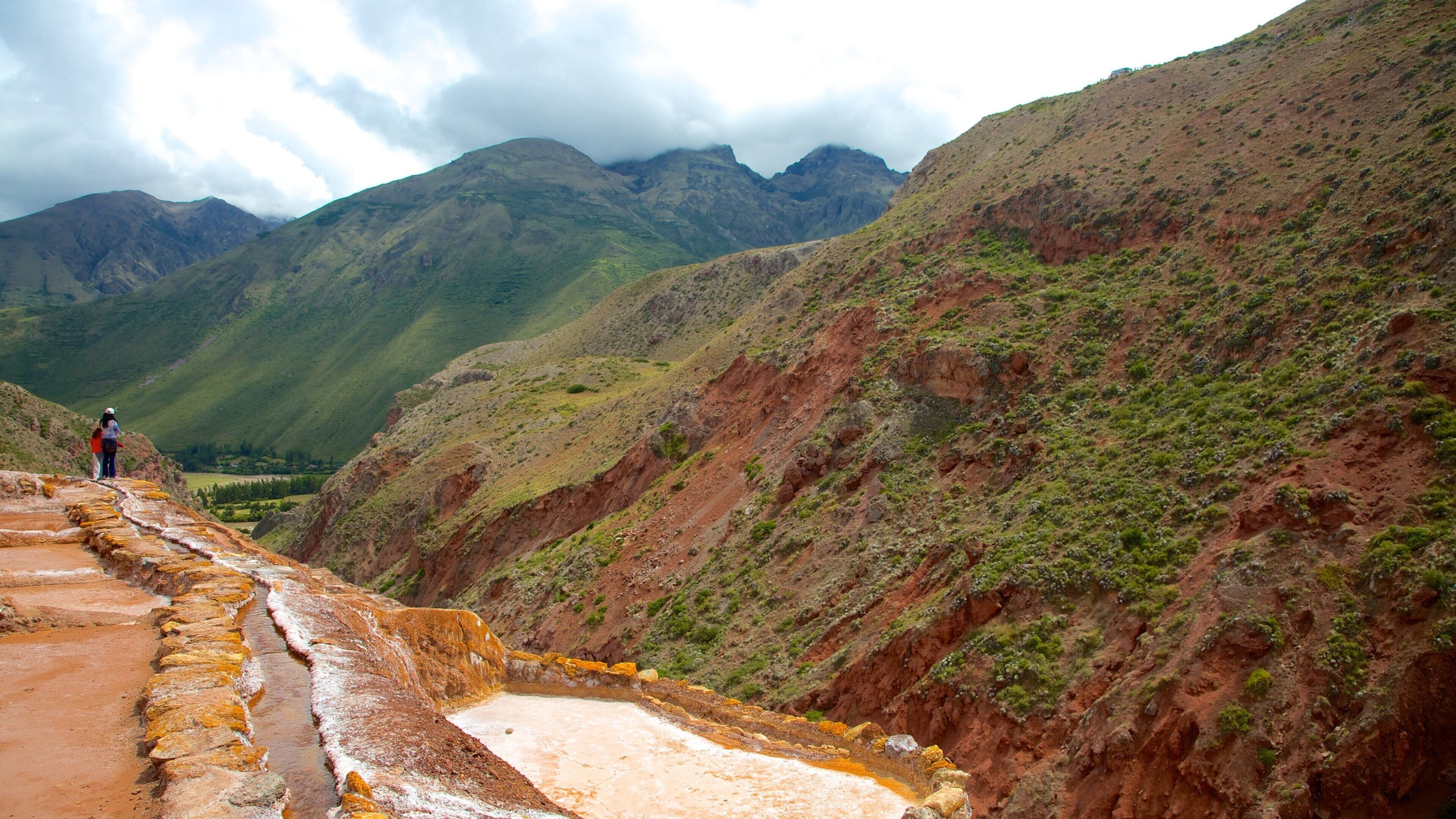 A terraced landscape with a river flowing through it, surrounded by mountains.