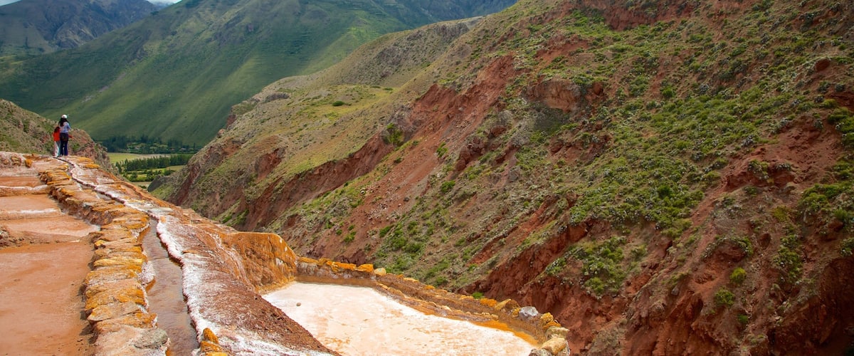 A terraced landscape with a river flowing through it, surrounded by mountains.