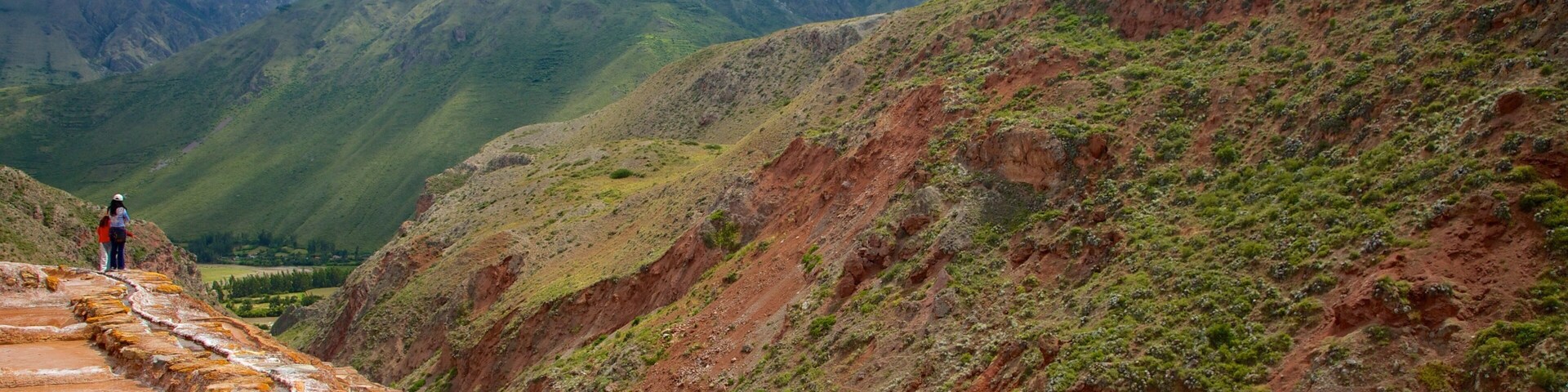 A terraced landscape with a river flowing through it, surrounded by mountains.