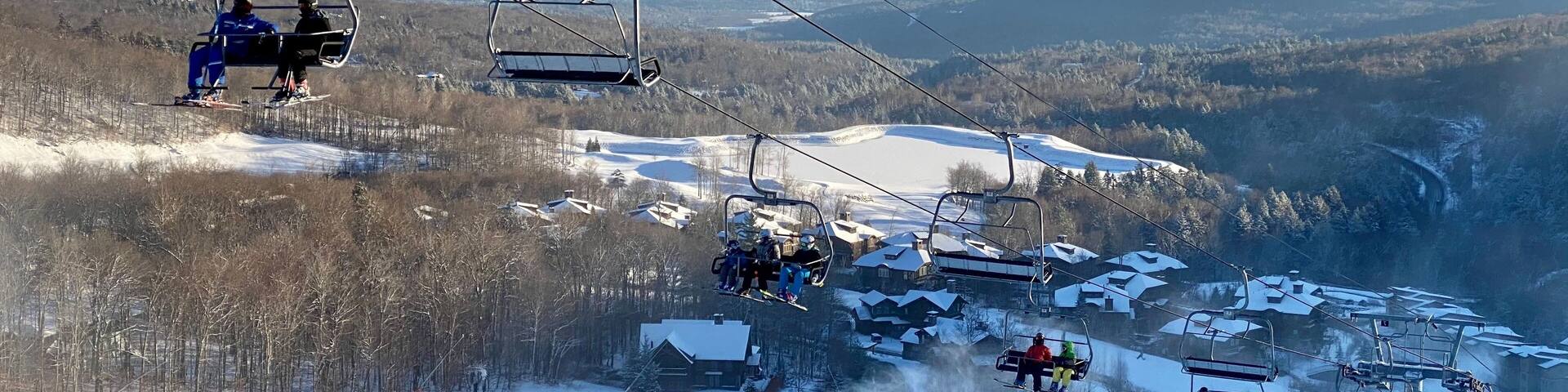 Skiers getting up at the chair lift at vermont ski resort