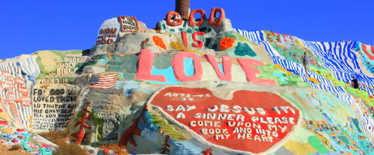 A colorful mural with a cross and the words "God is Love" prominently displayed.