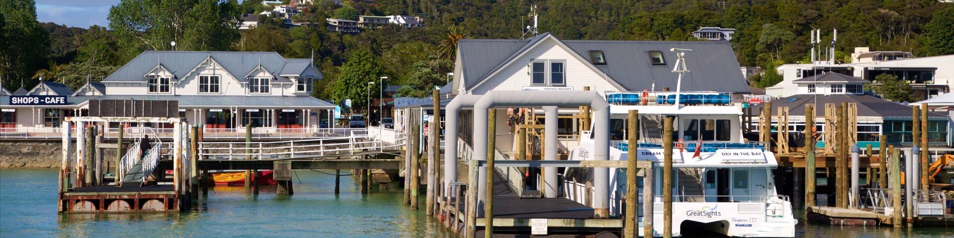 A waterfront pier with buildings and a boat docked.