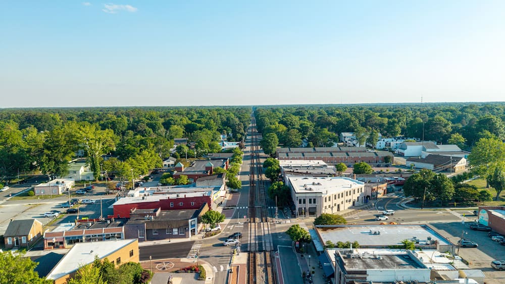 A town with a main street, buildings, and a train track.