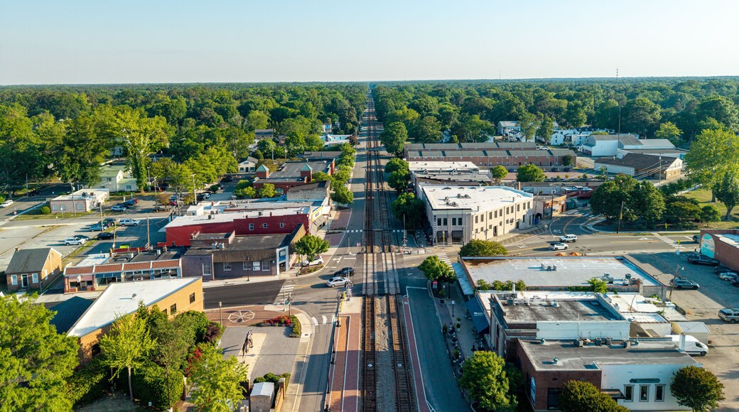 A town with a main street, buildings, and a train track.