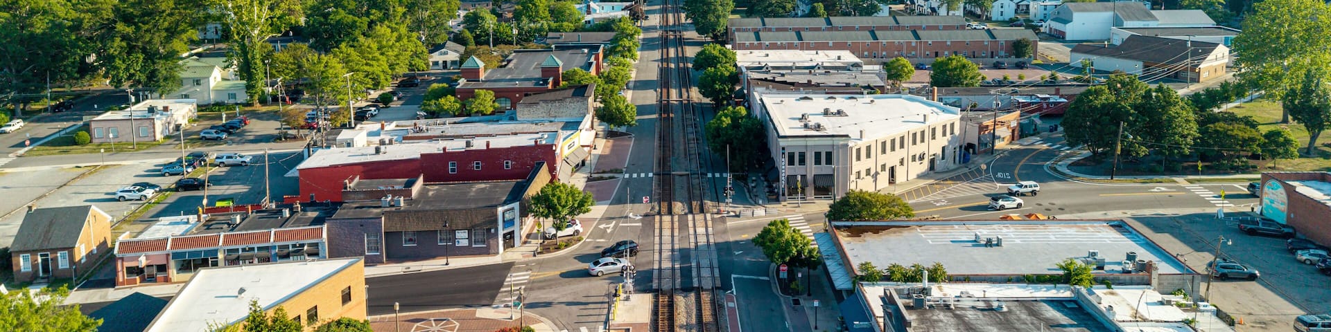 A town with a main street, buildings, and a train track.