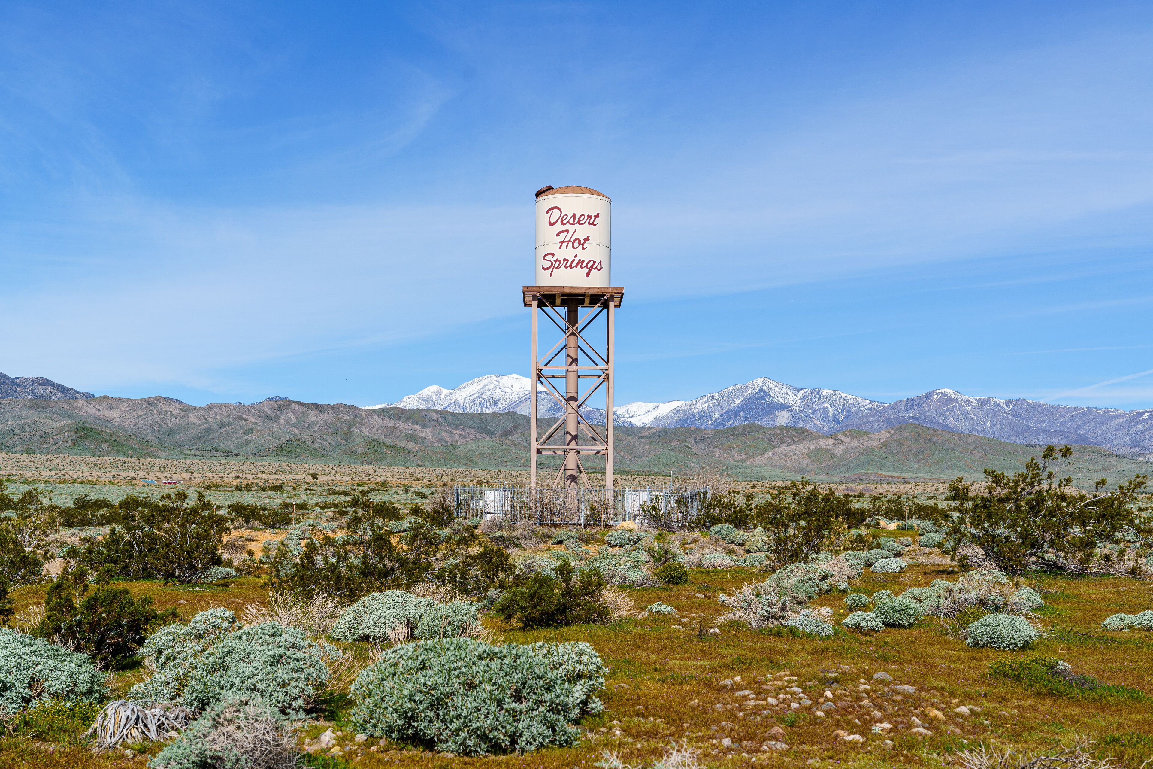 Desert Hot Springs, California water tower centered in frame with snow capped San Gorgonio Mountains in the background