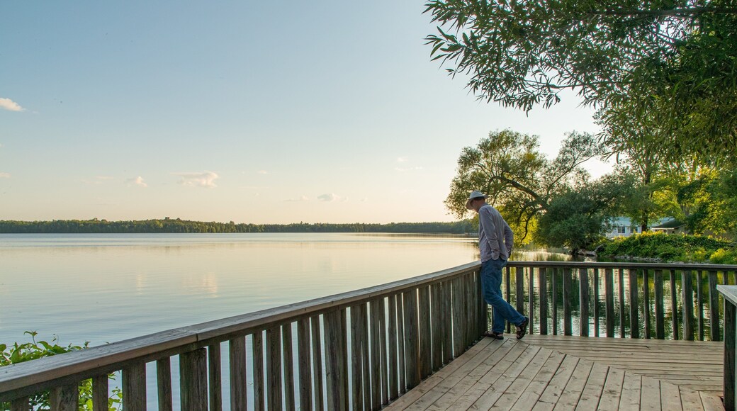 Lake on the Mountain Provincial Park showing a lake or waterhole and a sunset as well as an individual male