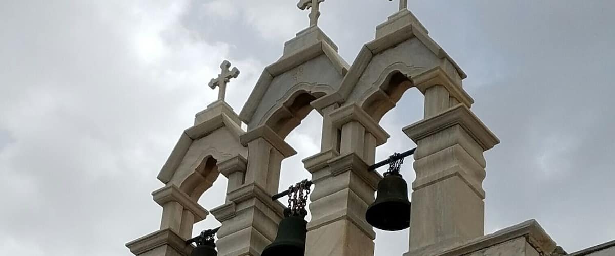 A church with three crosses and a bell tower.