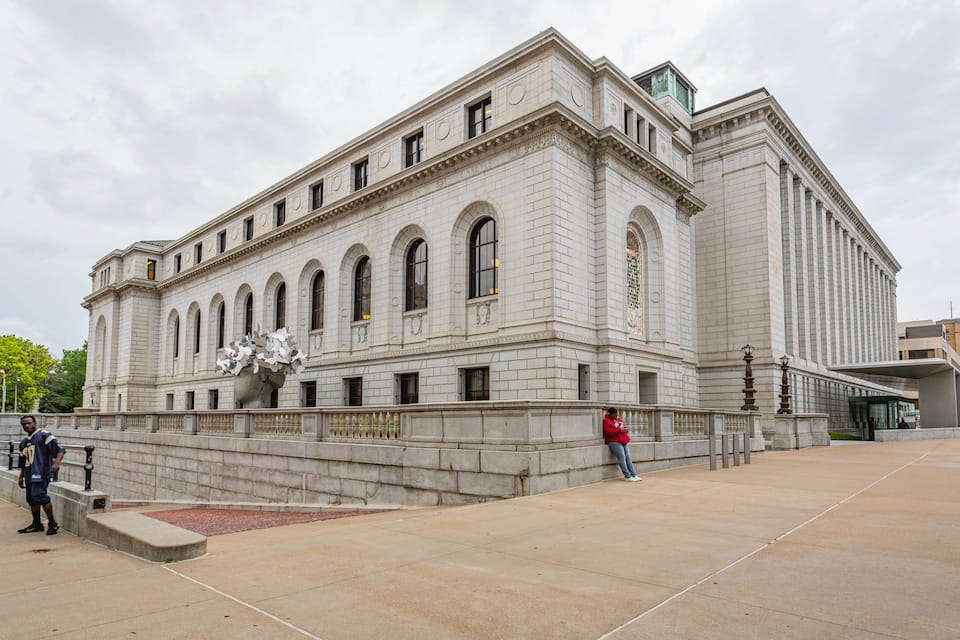 A large, historic building with arched windows and a prominent entrance.