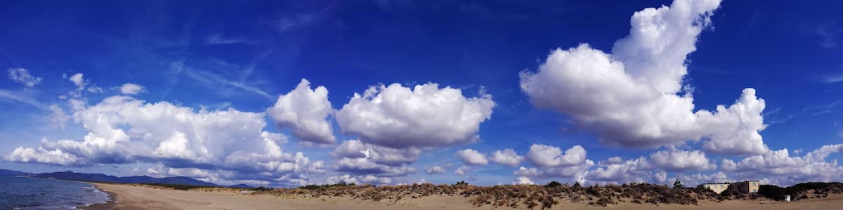 Italy, Tuscany, Maremma, Marina di Grosseto panoramic photo from the beach, in the background the port and castle of Castiglione della Pescaia.