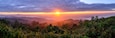 Panoramic view of sunrise with mist and mountain at Doi Pha Hom Pok in Chiang Mai, Thailand.