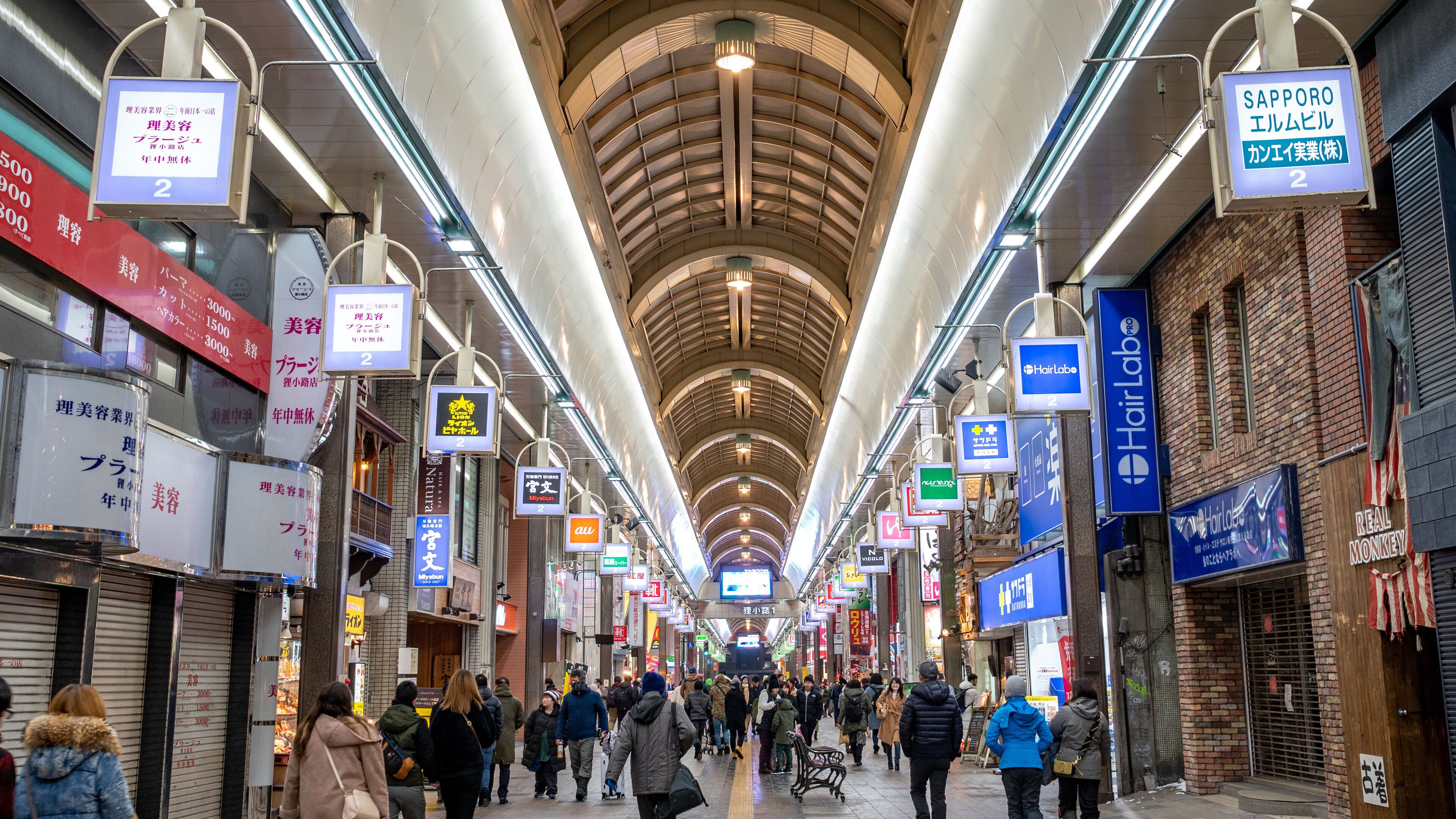 Tanukikoji Shopping Street showing interior views and signage as well as a large group of people