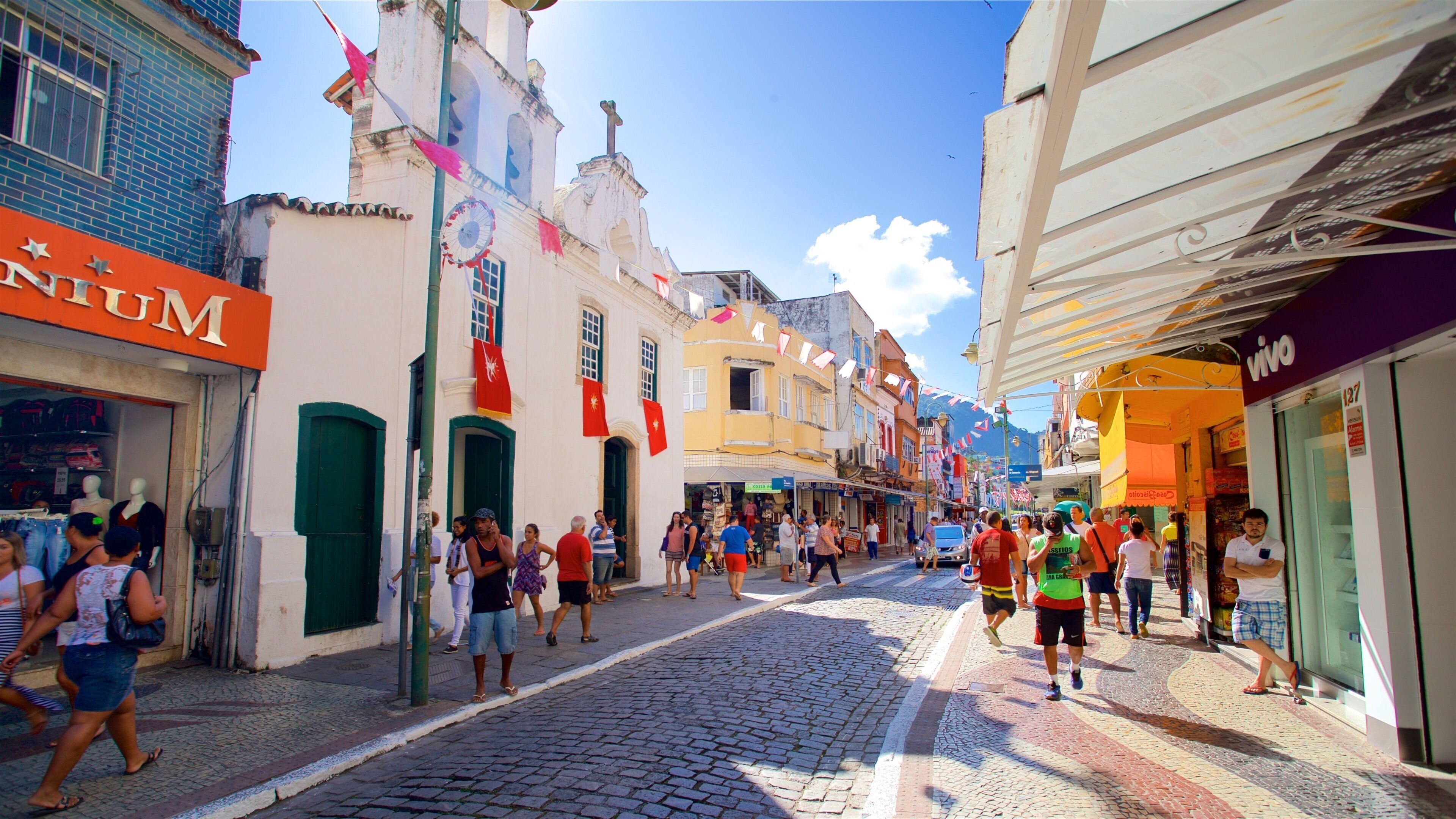 Santa Luzia Church showing a small town or village and street scenes as well as a small group of people