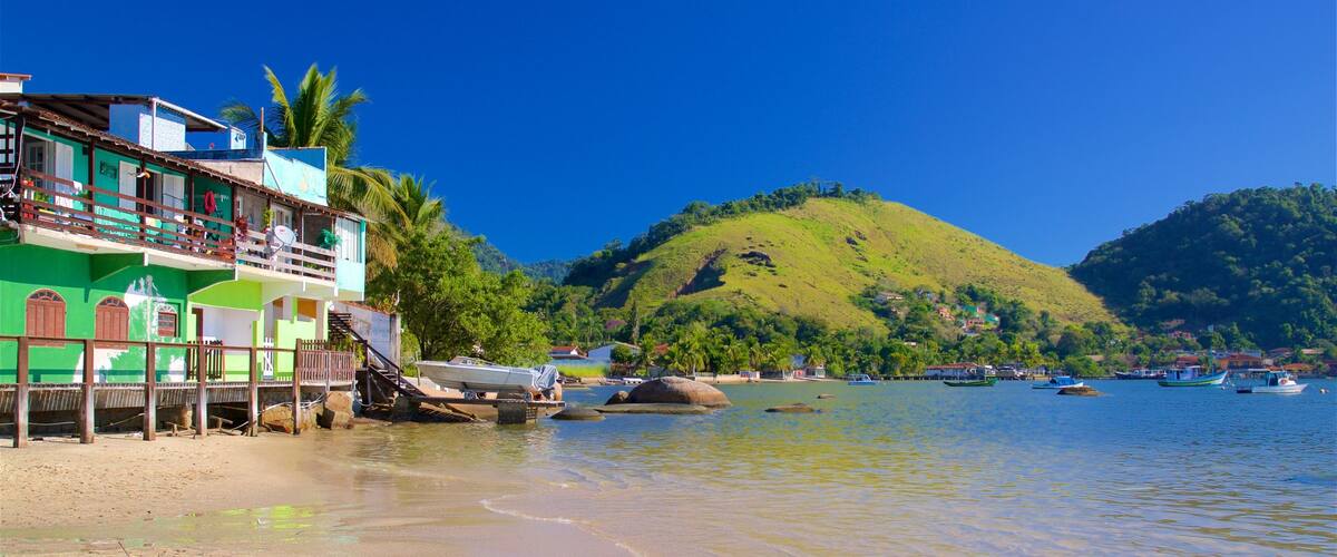 Enseada Beach which includes a coastal town, a bay or harbor and general coastal views