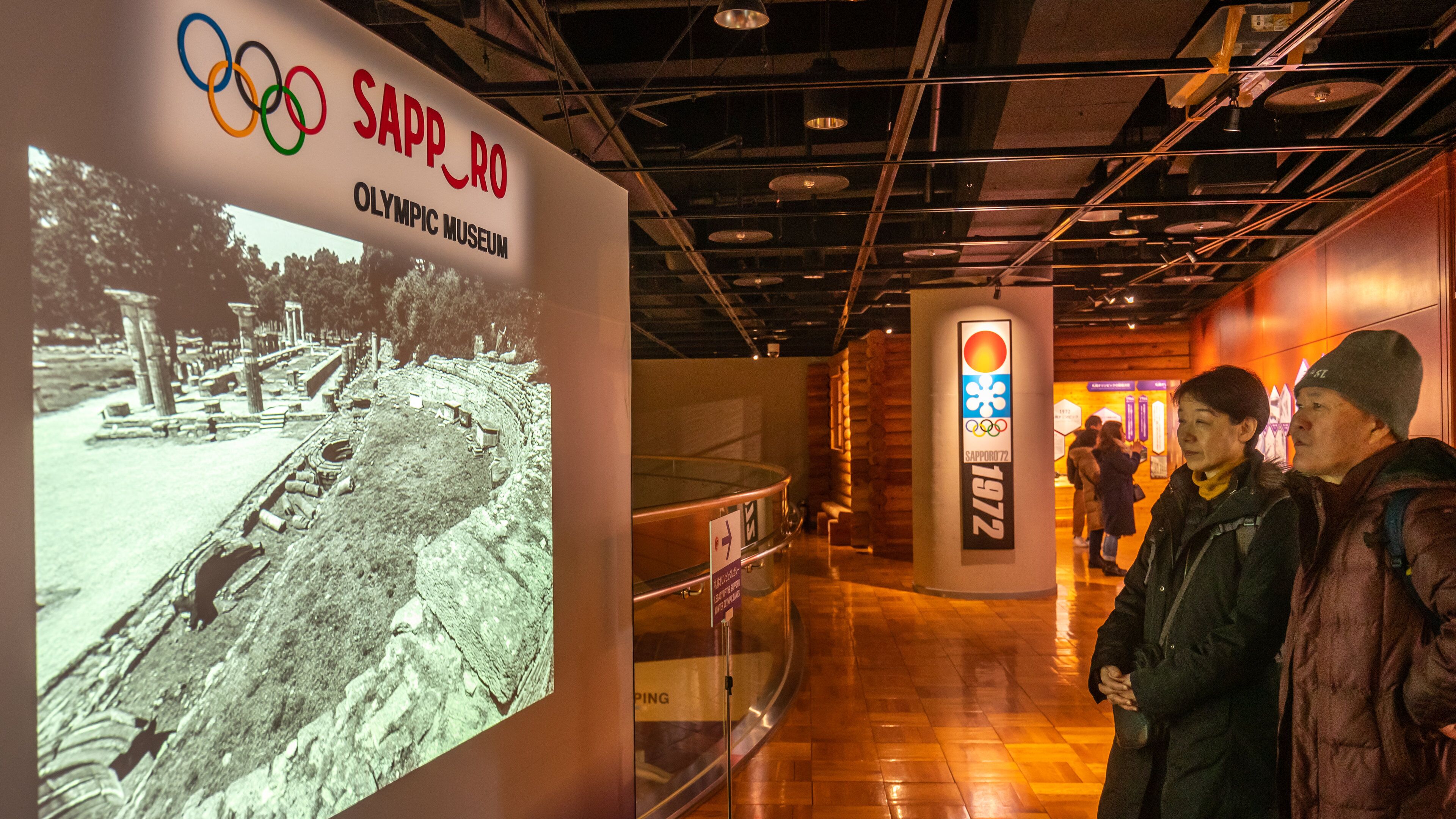 Sapporo Winter Sports Museum featuring interior views and signage as well as a couple