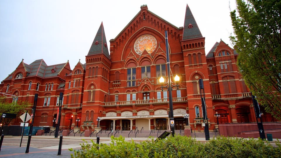 A large red brick building with a clock tower and arched windows.