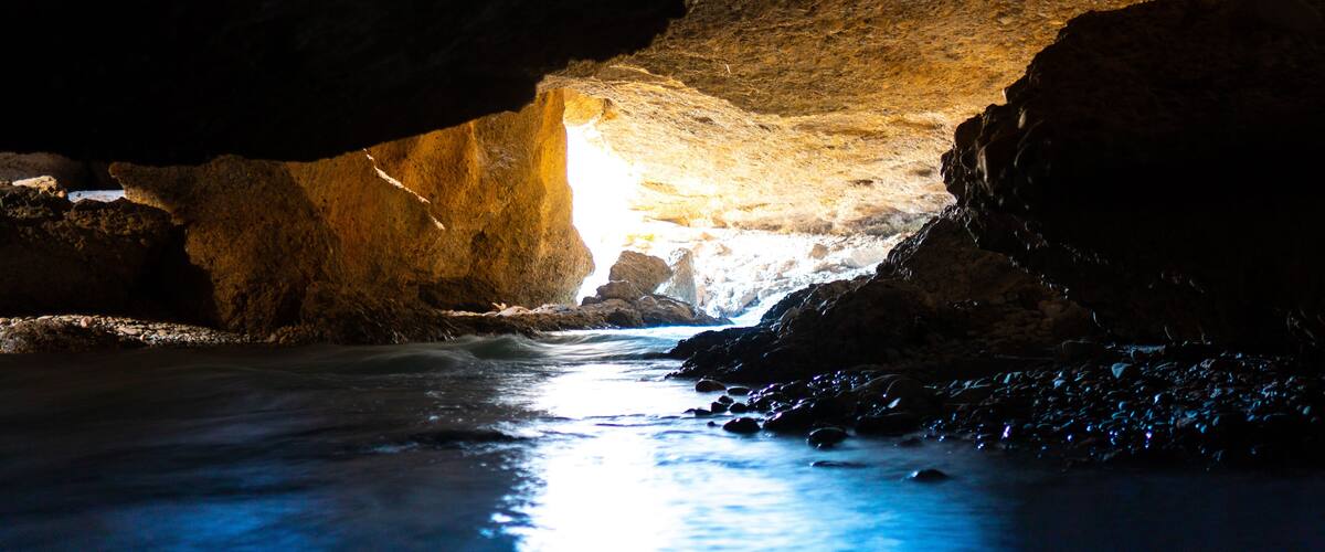 Panorama of the underground lake in a cave of bright blue color.