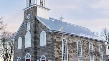 Une église en pierre dotée d’un clocher et d’un beffroi.