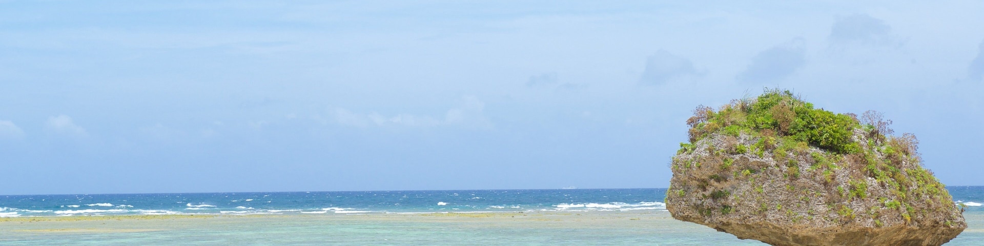 Nirai Beach which includes a sandy beach as well as a large group of people