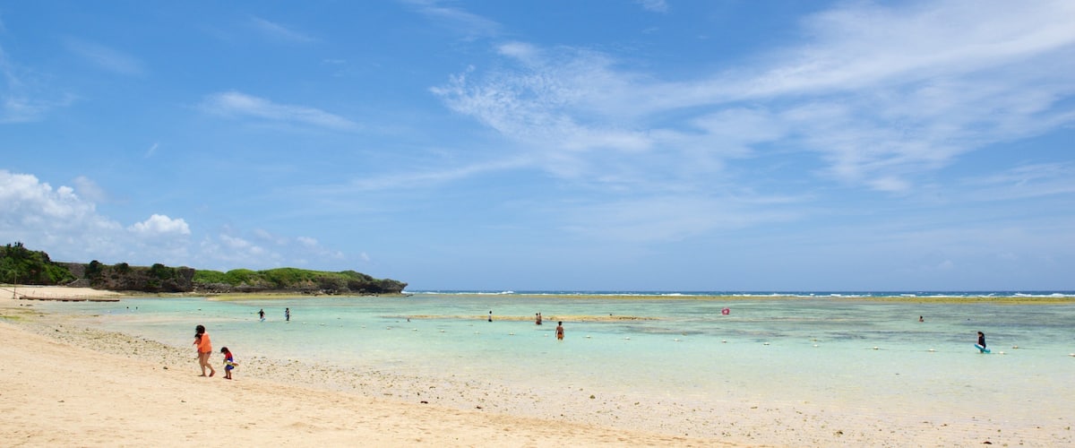 Nirai Beach which includes a sandy beach and swimming