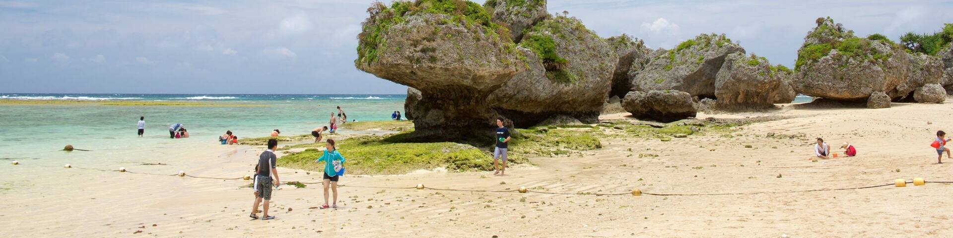 Nirai Beach featuring a sandy beach as well as children
