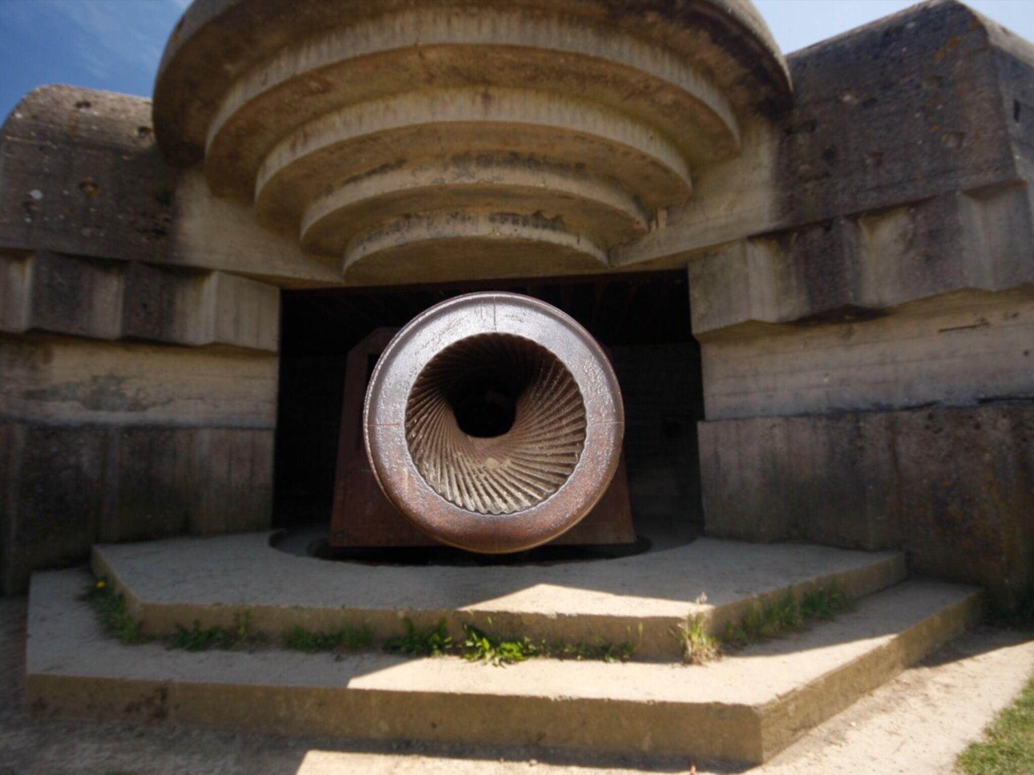 A large circular structure with concentric rings, set within a stone building.