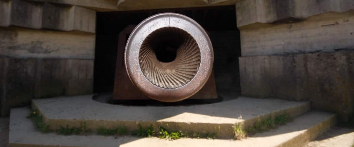 A large circular structure with concentric rings, set within a stone building.