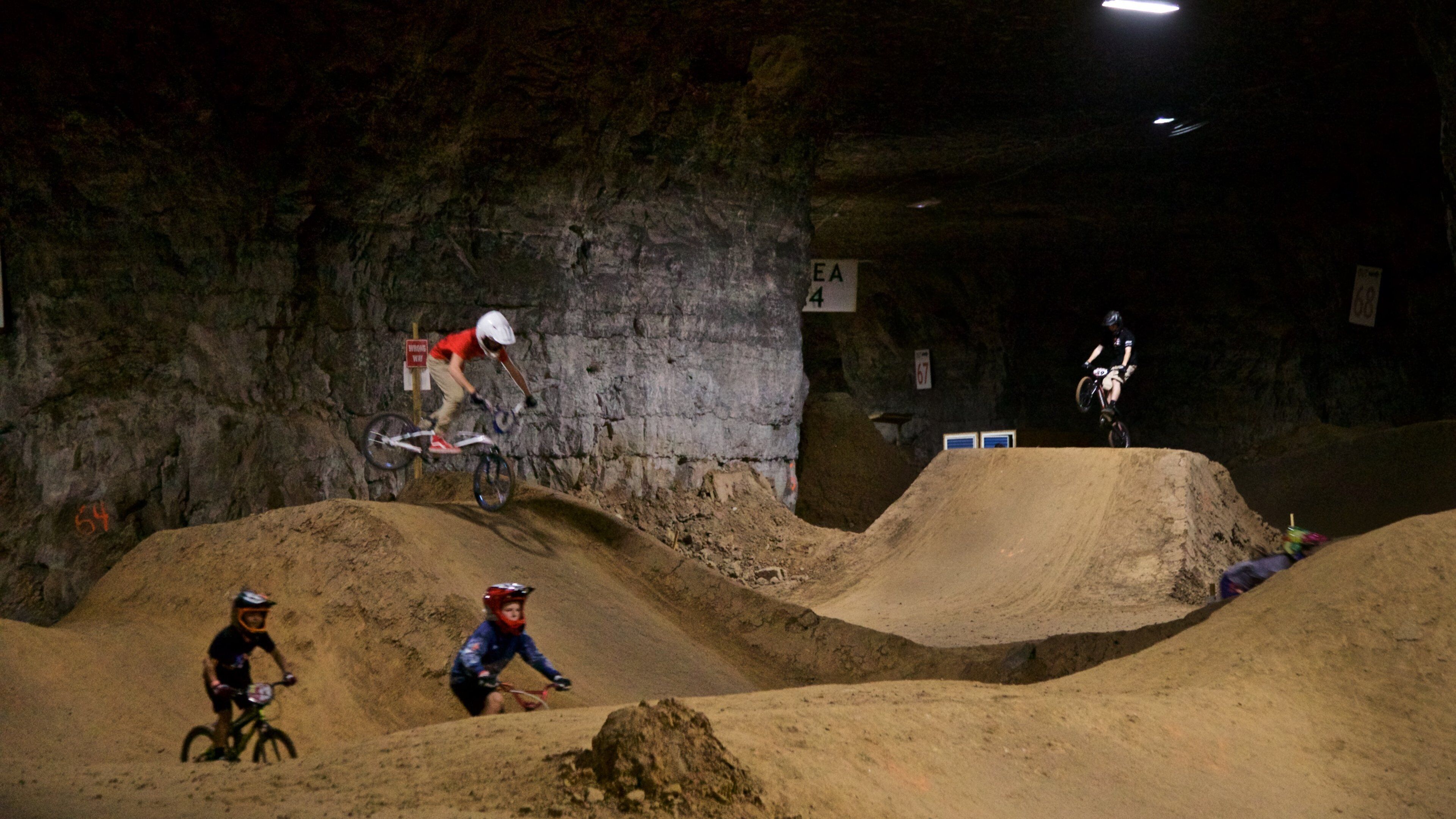 Louisville Mega Cavern featuring a sporting event, night scenes and mountain biking