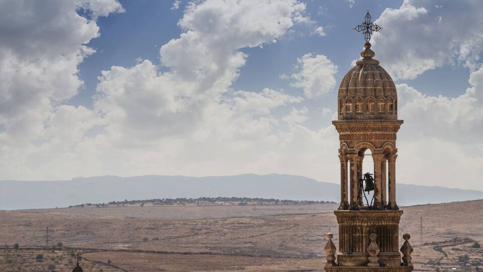 Bell tower of the church on the background of the valley Midyat Turkey