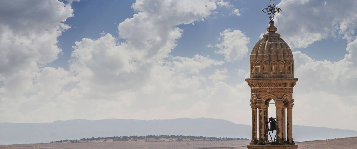 Bell tower of the church on the background of the valley Midyat Turkey