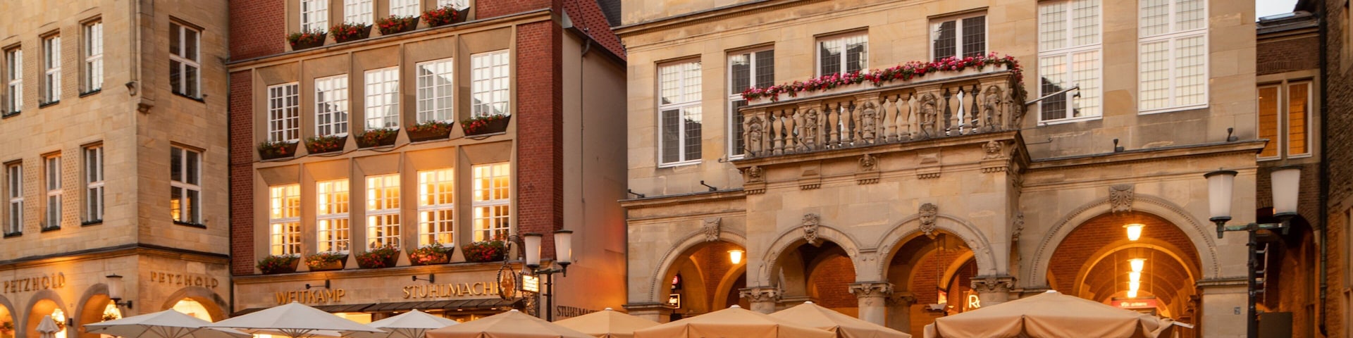 Prinzipalmarkt showing outdoor eating and a city as well as a small group of people