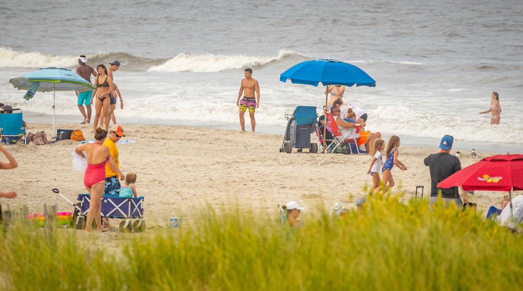 Sea Isle City showing a sandy beach and general coastal views as well as a large group of people