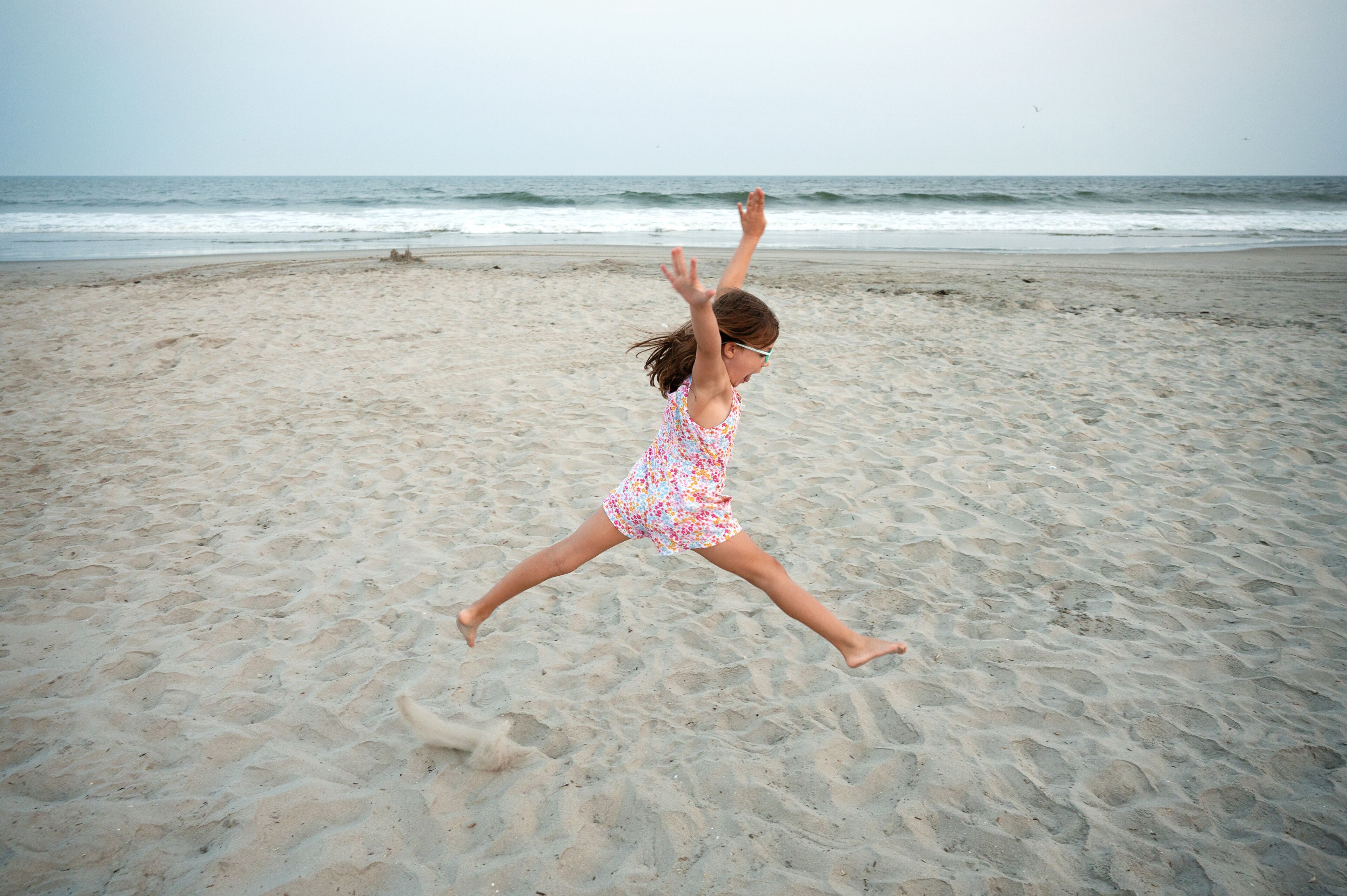 young girl dancing on the beach