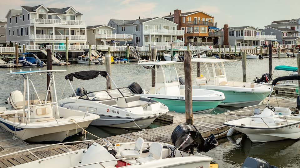 A marina with several boats docked at wooden piers.