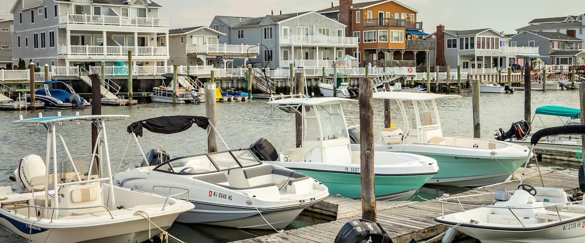 A marina with several boats docked at wooden piers.