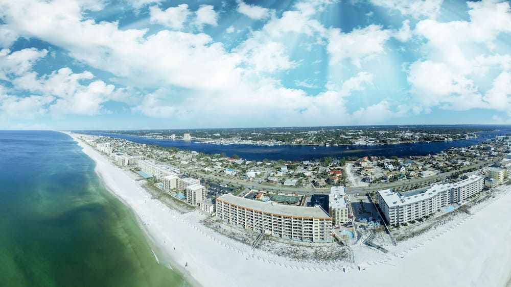 A coastal city with a long beach, a marina, and several large hotels.