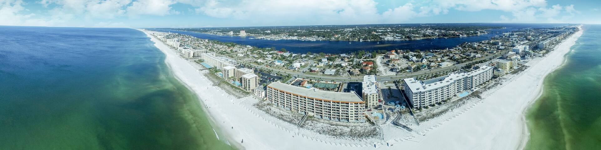A coastal city with a long beach, a marina, and several large hotels.