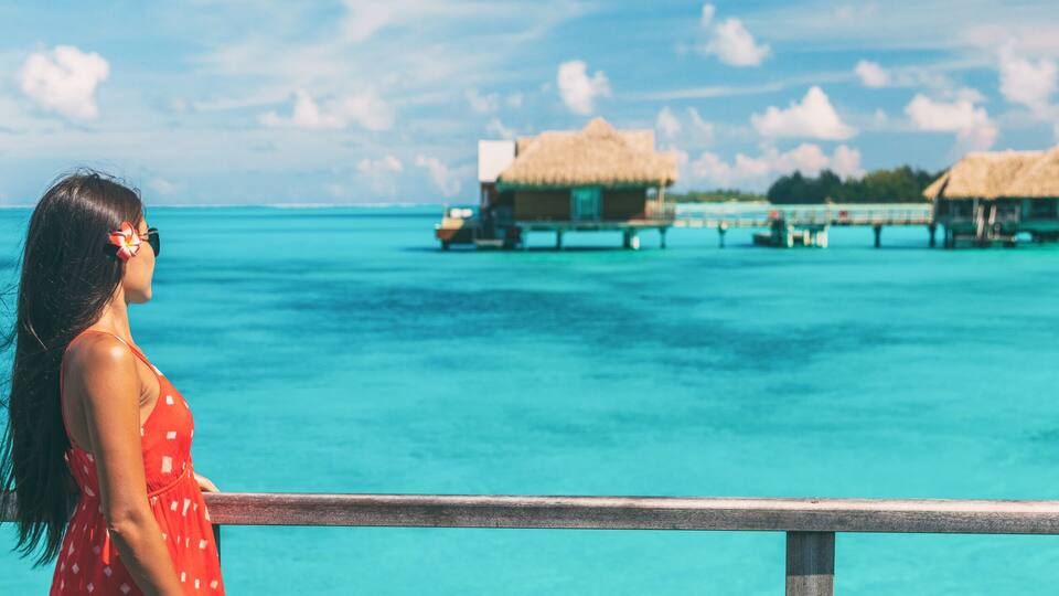 luxury resort honeymoon vacation cruise destination in Bora Bora island, Tahiti, French Polynesia. Woman walking on idyllic beach landscape header banner.