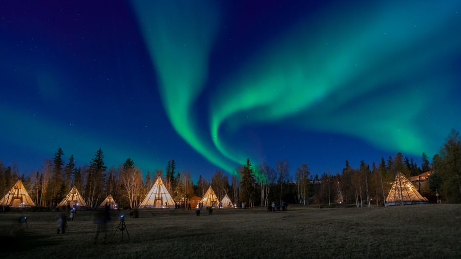Many lightup Tipi with Aurora Borealis at Yellow Knife