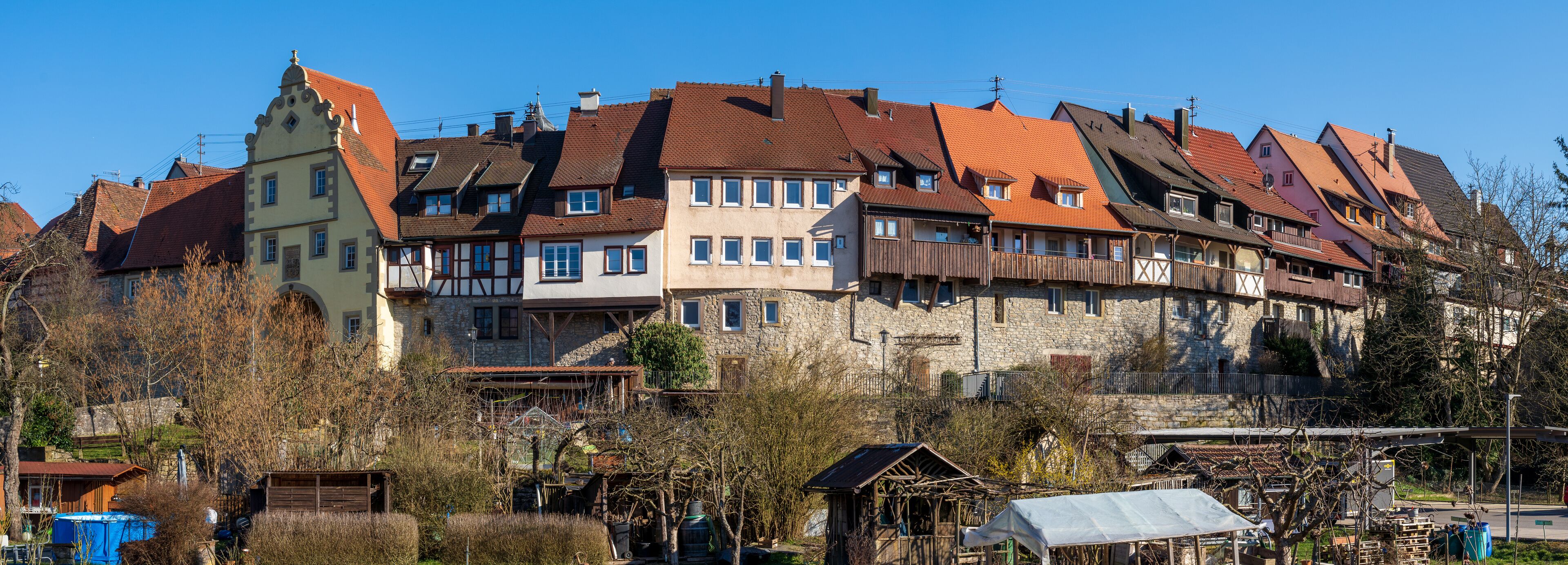 A row of traditional European houses with red-tiled roofs and timber framing.
