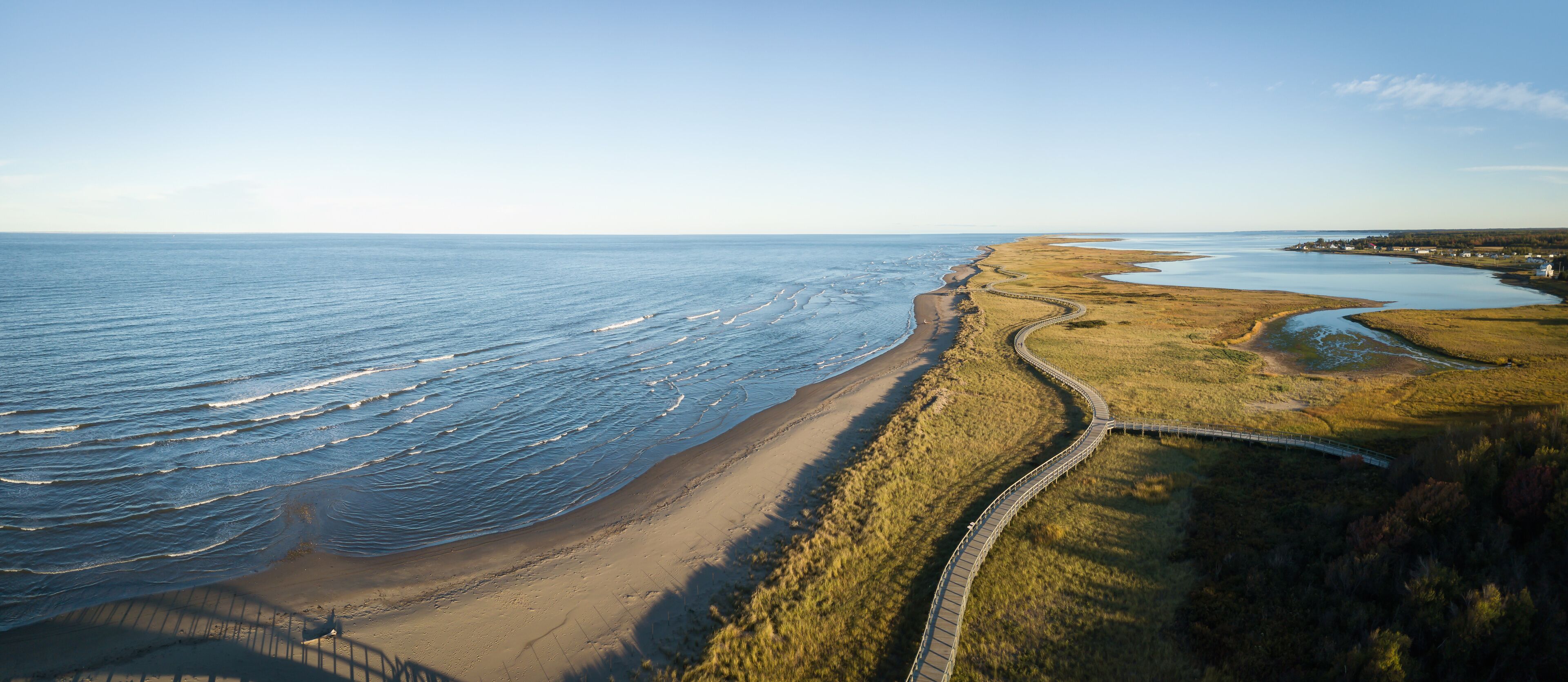 Aerial panoramic view of a beautiful sandy beach on the Atlantic Ocean Coast. Taken in La Dune de Bouctouche, New Brunswick, Canada.